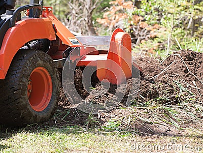 Closeup of a Utility Tractor With Tiller in Action Stock Photo