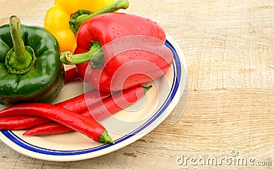 Closeup various peppers rural kitchen table on plate Stock Photo