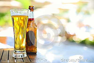 Closeup view of beer bottle and the glass in the garden Stock Photo