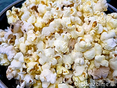 A closeup view of bowl of popcorn on a wooden table Stock Photo