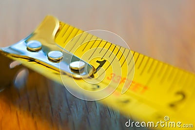 A closeup view of a common tape measure showing the start of the measuring scale Stock Photo