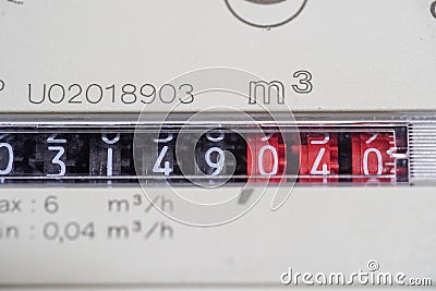 A closeup view of the dial or face of a metric gas meter in home Stock Photo