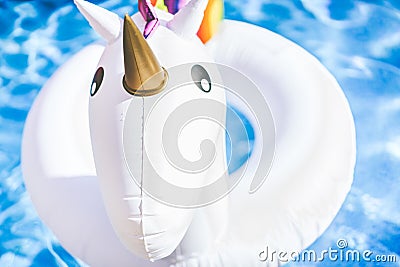 Closeup view of Inflatable colorful white unicorn at the swimming pool. Fun time in the Summer at swimming pool. concept. Stock Photo