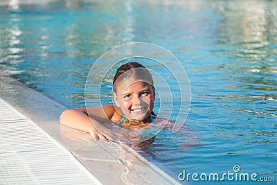 Closeup view of joyful happy little girl swimming in water pool Stock Photo