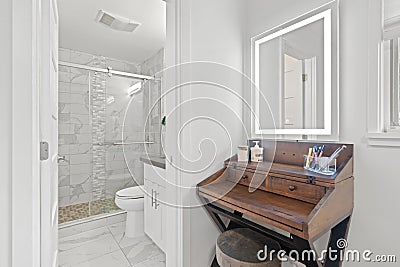 Elegant master bathroom and a freestanding makeup vanity Stock Photo