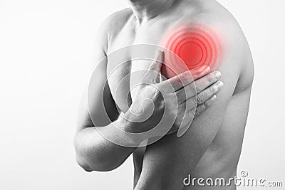 Closeup view of a male shirtless body showing shoulder deltoids muscle pain Stock Photo