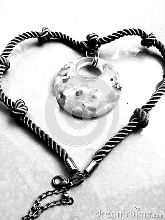 A Closeup view of a necklace with stone pendant and rope link. Stock Photo