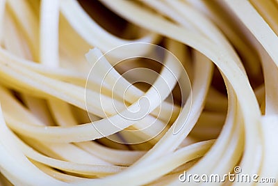 Closeup view of a Pile Of Uncooked Rolled Traditional Italian Pasta Stock Photo