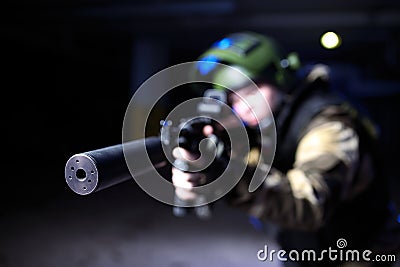 Closeup view on silencer on mashine gun in military hands Stock Photo