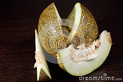 Sliced melon on dark wooden table Stock Photo