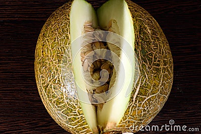 Sliced melon on dark wooden table Stock Photo