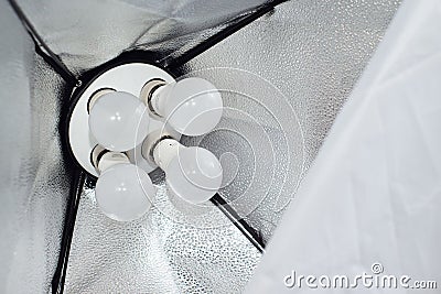 Closeup view of studio light bulb on softbox. Stock Photo