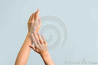 Closeup view of woman hands applying hand cream. beauty shot Stock Photo