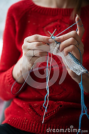 Closeup view of a woman knitting a scarf Stock Photo