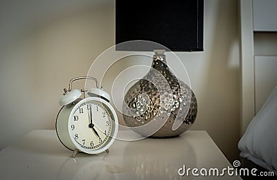 Closeup vintage clock in the bedroom showing 5am 5 oclock in the morning. Stock Photo