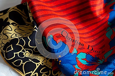 Closeup of vintage silk Christian Dior scarves in red and blue and yellow and black Editorial Stock Photo
