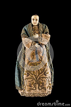 Closeup of a vintage statue of a female with a beautiful dress isolated on a black background Stock Photo