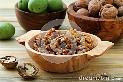 Walnuts green and dry on kitchen table background Stock Photo