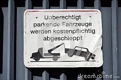 Closeup of a warning sign in German language illegally parked cars will be towed away Germany Stock Photo