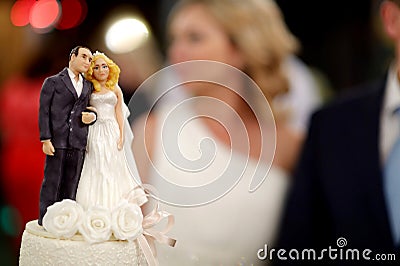 Closeup of wedding cake figurines at reception Stock Photo