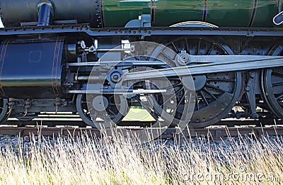 Closeup of wheels and con rods of renovated steam engine in England Stock Photo