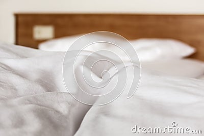 Closeup white bedding sheets in a hotel room Stock Photo