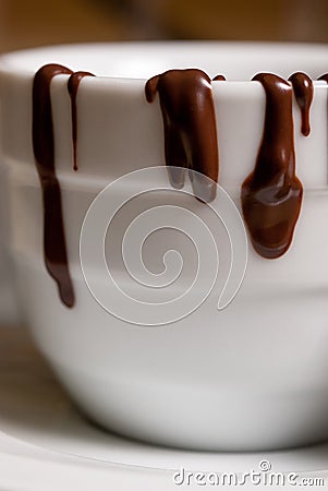 Closeup of White cofee cup with chocolate flowing Stock Photo