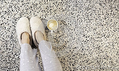 Closeup of white wool slippers and coffee everyday lifestyle scene Stock Photo