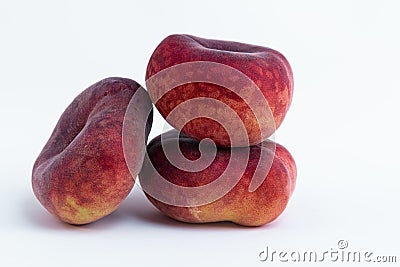 Closeup of whole flat peaches isolated on a white background Stock Photo