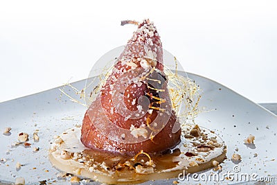 closeup whole pear exclusive decorated with caramel against white Stock Photo