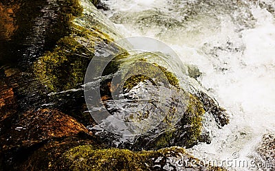 Closeup of a wild, pristine waterfall cascading over rocks in a natural landscape. Stock Photo