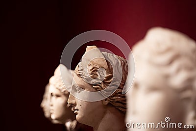 Closeup of woman antique statues on red background Stock Photo