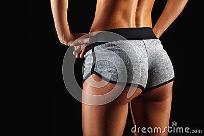 Closeup woman buttocks over dark Stock Photo