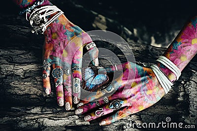 Closeup of woman colorful hands on tree surface in heart shape Stock Photo