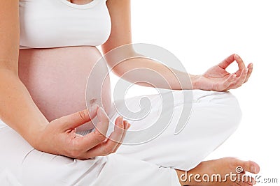 Closeup of woman doing meditative pregnancy yoga Stock Photo