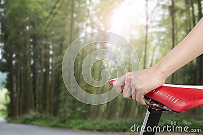 Closeup on woman hand holding bike seat Stock Photo