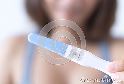 Closeup woman hand holding pregnancy test with happy moment, health care concept, selective focus Stock Photo