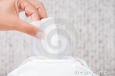 Closeup woman hand holding wet wipes from package. Stock Photo