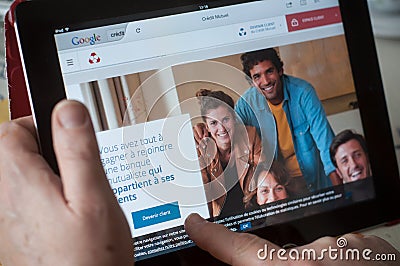 Closeup of woman hands on the credit mutuel french bank home page of web site on tablet Editorial Stock Photo