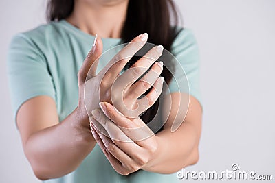 Closeup woman holds her wrist hand injury, feeling pain. Health care and medical conept Stock Photo