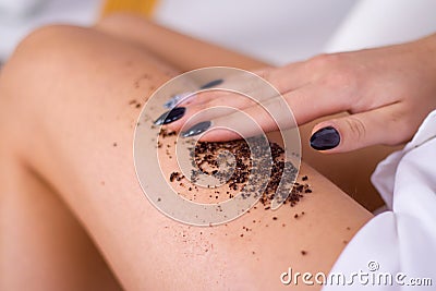 closeup woman legs with coffee massage scrub. Cosmetology, grooming, Spa cosmetic products, beauty and bikini concept Stock Photo