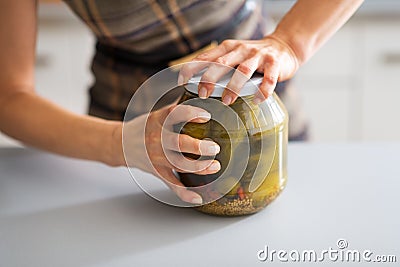 Closeup on woman opening jar of pickled cucumbers Stock Photo
