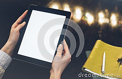 Closeup of a woman pointing finger to an blank display of the tablet with a blue color in a homelike atmosphere on warm bokeh back Stock Photo