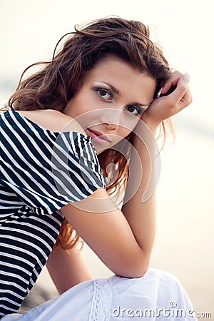 Closeup woman portrait sitting on ground Stock Photo