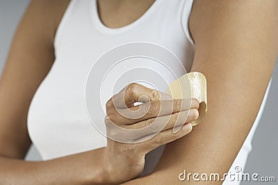 Closeup Of Woman Putting Nicotine Patch On Arm Stock Photo