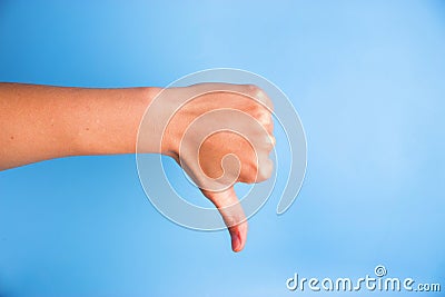 Closeup of woman's hand gesturing thumbs down Stock Photo
