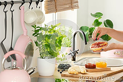 Closeup of woman`s hands above a wooden countertop with a cuttin Stock Photo