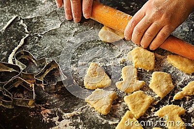 Closeup of woman`s hands working with dough and making biscuits Stock Photo