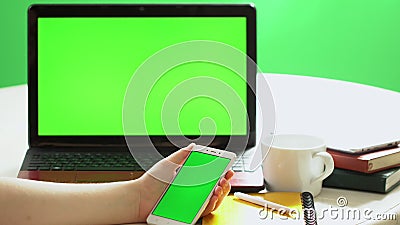 Closeup woman sitting table notebook female hands keyboarding laptop using texting pointing networking green screen. Chroma key chromakey keyboard white device stock video footage Closeup woman sitting table notebook female hands keyboarding laptop using texting pointing networking green screen. Chroma key chromakey keyboard white device stock video footage