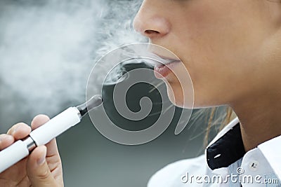 Closeup of woman smoking electronic cigarette outdoor Stock Photo